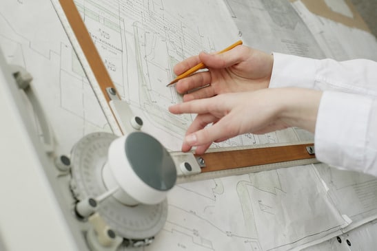 An image of two architects' hands doing work - image licensed from Photodune