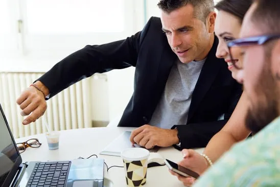 Portrait of casual executives working together at a meeting with laptop. - image licensed from Photodune
