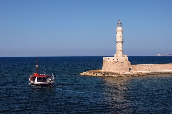 Lighthouse and a boat- image licensed from Photodune