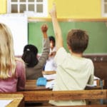 children raising their hand in the classroom - from iStockPhoto